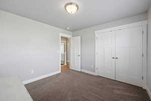Unfurnished bedroom featuring carpet floors and a closet