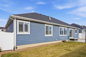 Rear view of house featuring roof with shingles