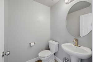 Bathroom with toilet and baseboards