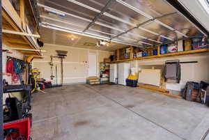 Garage featuring freestanding refrigerator and white fridge