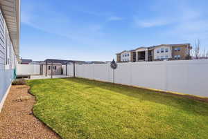 Fenced backyard with a patio and a pergola