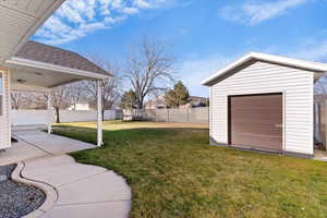 Fenced backyard with a storage shed