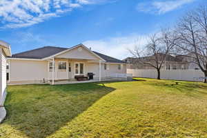 Rear view of house with a fenced backyard, a patio, french doors, and a trampoline