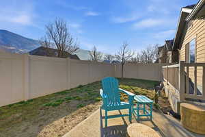 Fenced backyard featuring a patio area and a mountain view