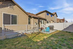 Back of house featuring a patio and roof with shingles