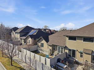 Back of property with roof with shingles, a fenced backyard, and entry steps