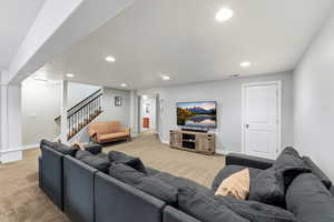 Living room featuring light colored carpet and recessed lighting