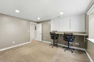 Office featuring light colored carpet and recessed lighting