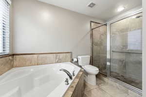Full bath with a garden tub, a shower stall, and recessed lighting