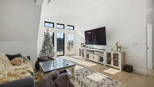 Living room with vaulted ceiling and light wood finished floors