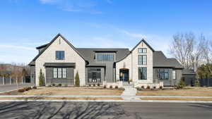 French country style house with stone siding and a shingled roof