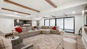Living area featuring beamed ceiling, recessed lighting, and wood finished floors