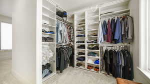 Walk in closet featuring light carpet