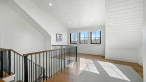 Hallway with light wood finished floors, recessed lighting, and a vaulted wooden ceiling