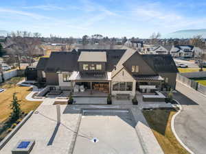 Back of house featuring a patio area, a fenced backyard, a standing seam roof, a residential view, and outdoor lounge area