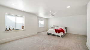 Bedroom featuring light carpet, a ceiling fan, and recessed lighting