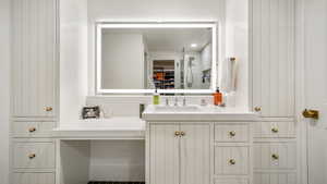 Bathroom featuring vanity and a shower