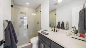 Full bathroom featuring vanity and a shower stall