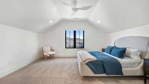 Carpeted bedroom with a ceiling fan and recessed lighting