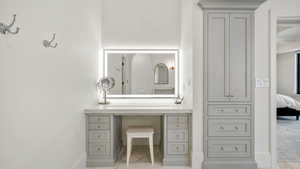 Ensuite bathroom featuring vanity and baseboards