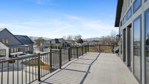 Balcony featuring a residential view and a mountain view