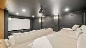 Home theater room featuring a decorative wall and recessed lighting