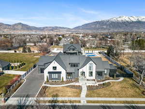 View of front of house featuring asphalt driveway, a mountain view, and stone siding