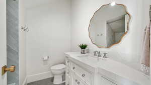 Bathroom with vanity and dark tile patterned flooring