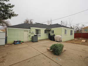 Rear view of property featuring a patio area and roof with shingles