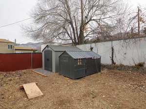 View of shed featuring a fenced backyard