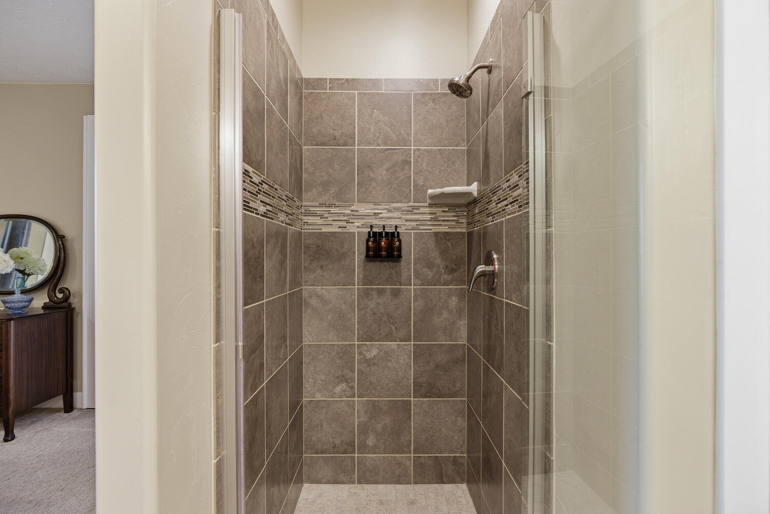 Full bath with a stall shower and carpet flooring