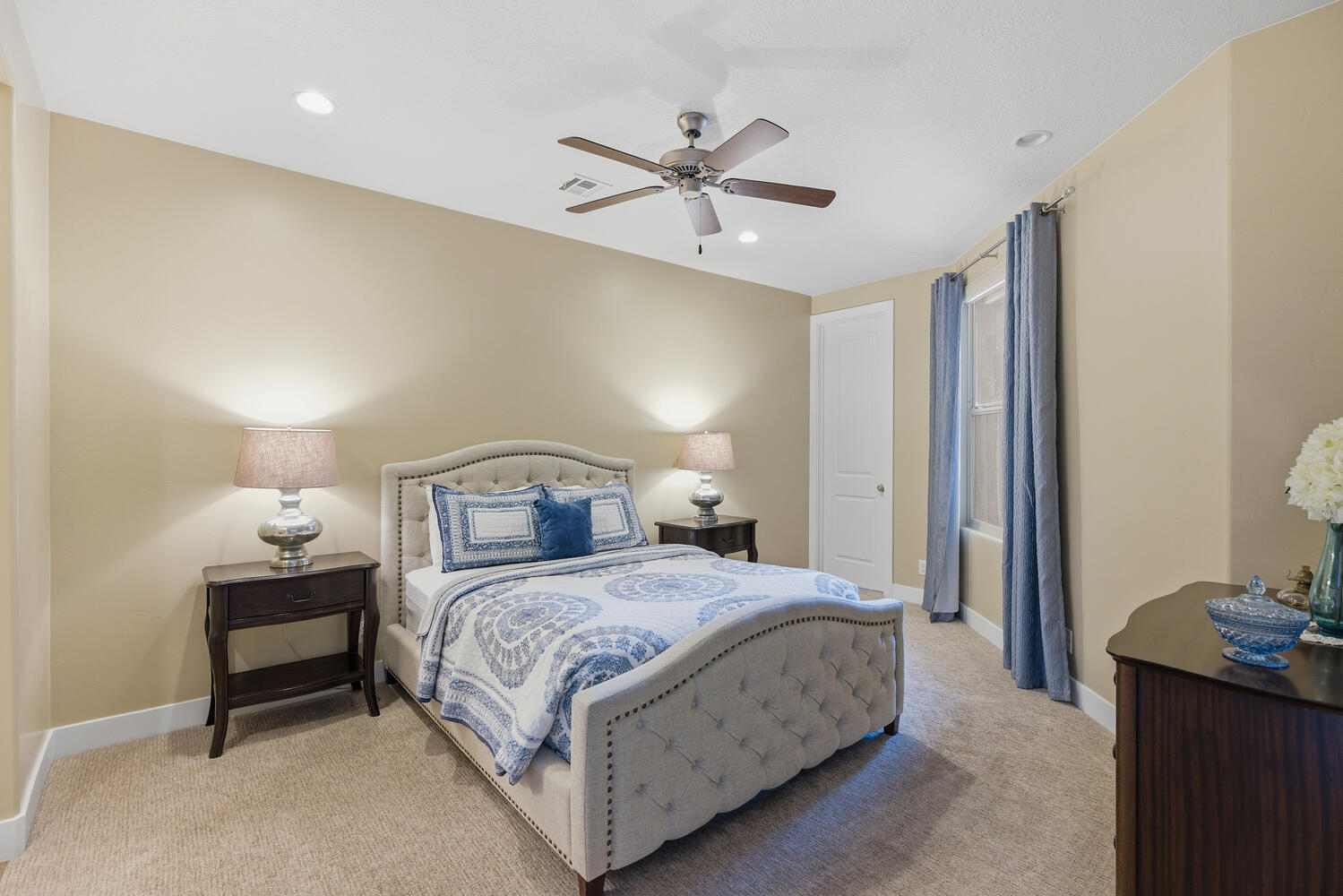 Bedroom with light colored carpet, ceiling fan, and recessed lighting