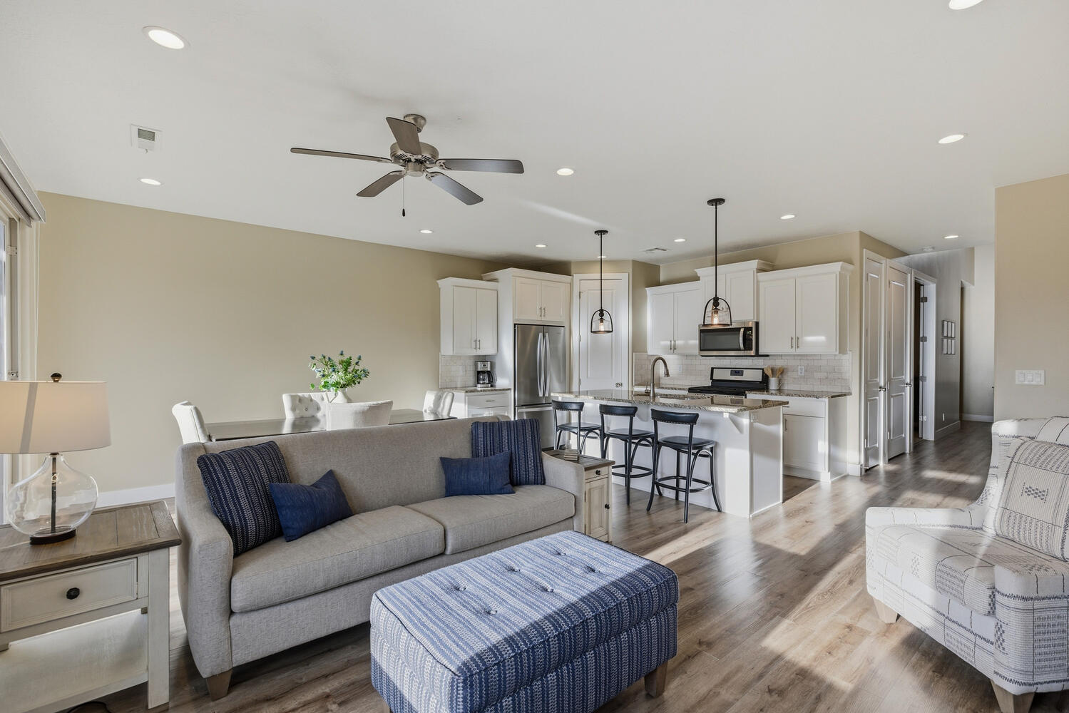 Living area featuring light wood-type flooring, ceiling fan, and recessed lighting