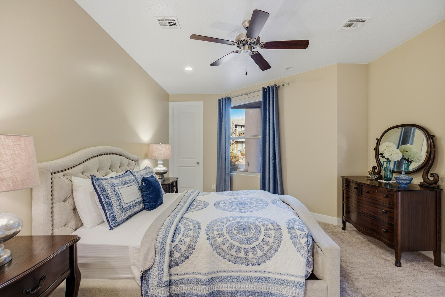 Bedroom featuring carpet flooring, ceiling fan, and vaulted ceiling