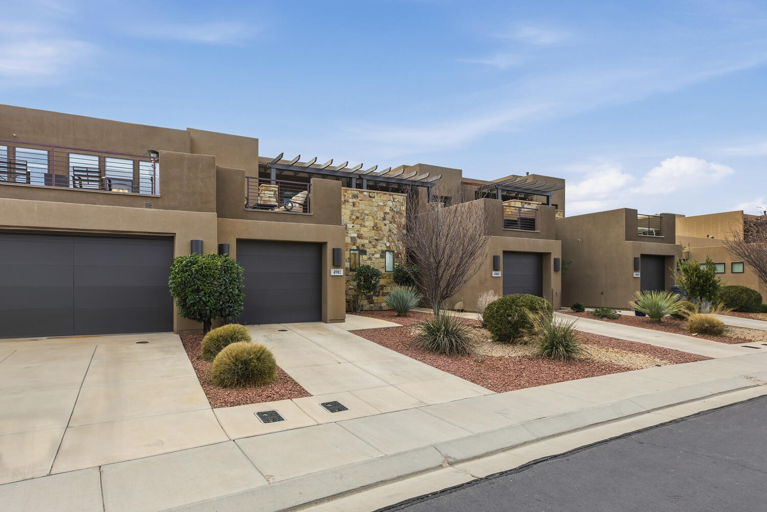 View of front of house featuring stucco siding, concrete driveway, and a garage