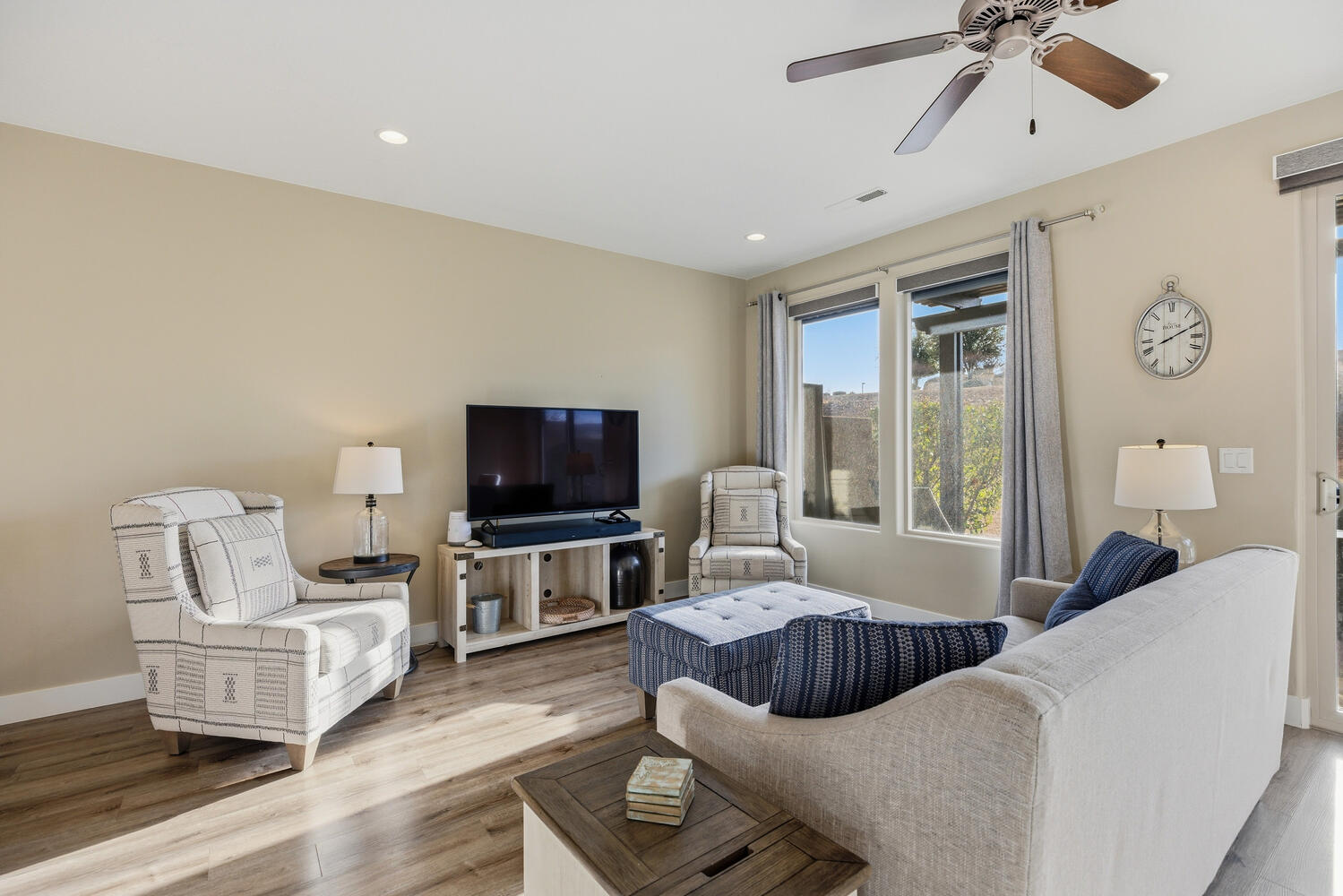 Living room featuring wood finished floors, ceiling fan, and recessed lighting