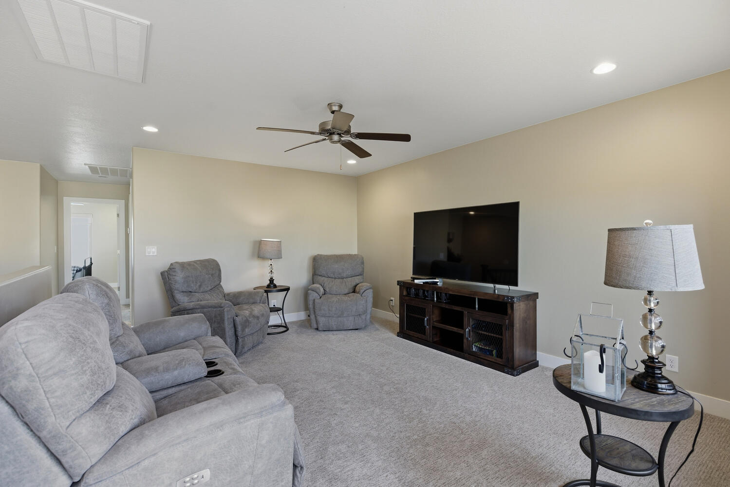 Living room featuring carpet, recessed lighting, and a ceiling fan