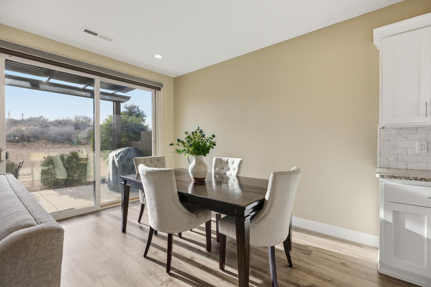 Dining space with light wood-style floors and recessed lighting