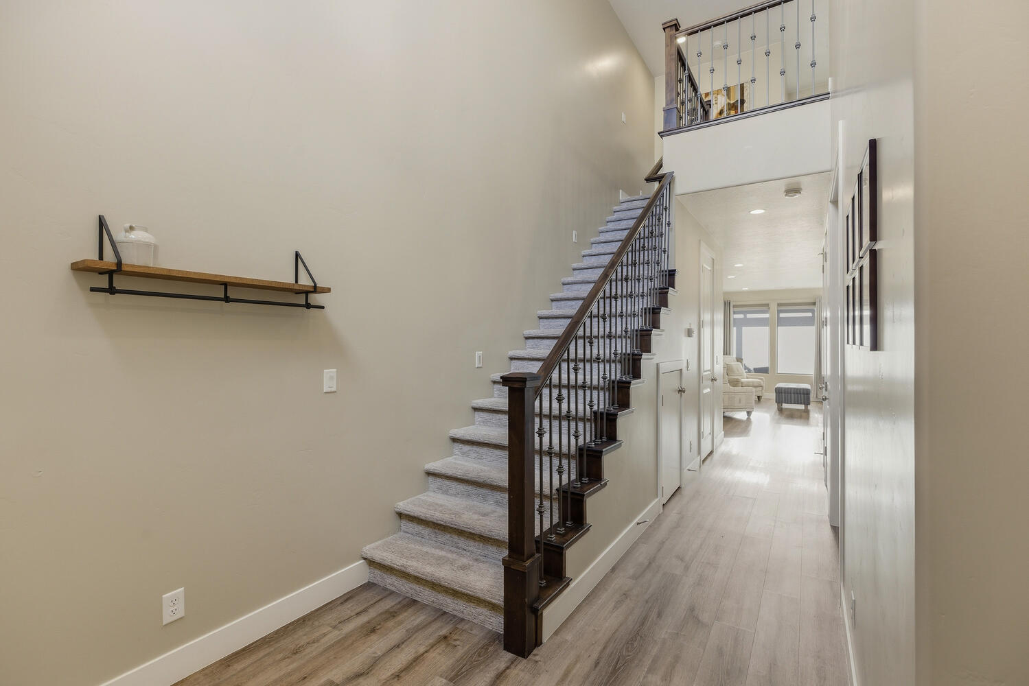 Stairway featuring wood finished floors and a high ceiling