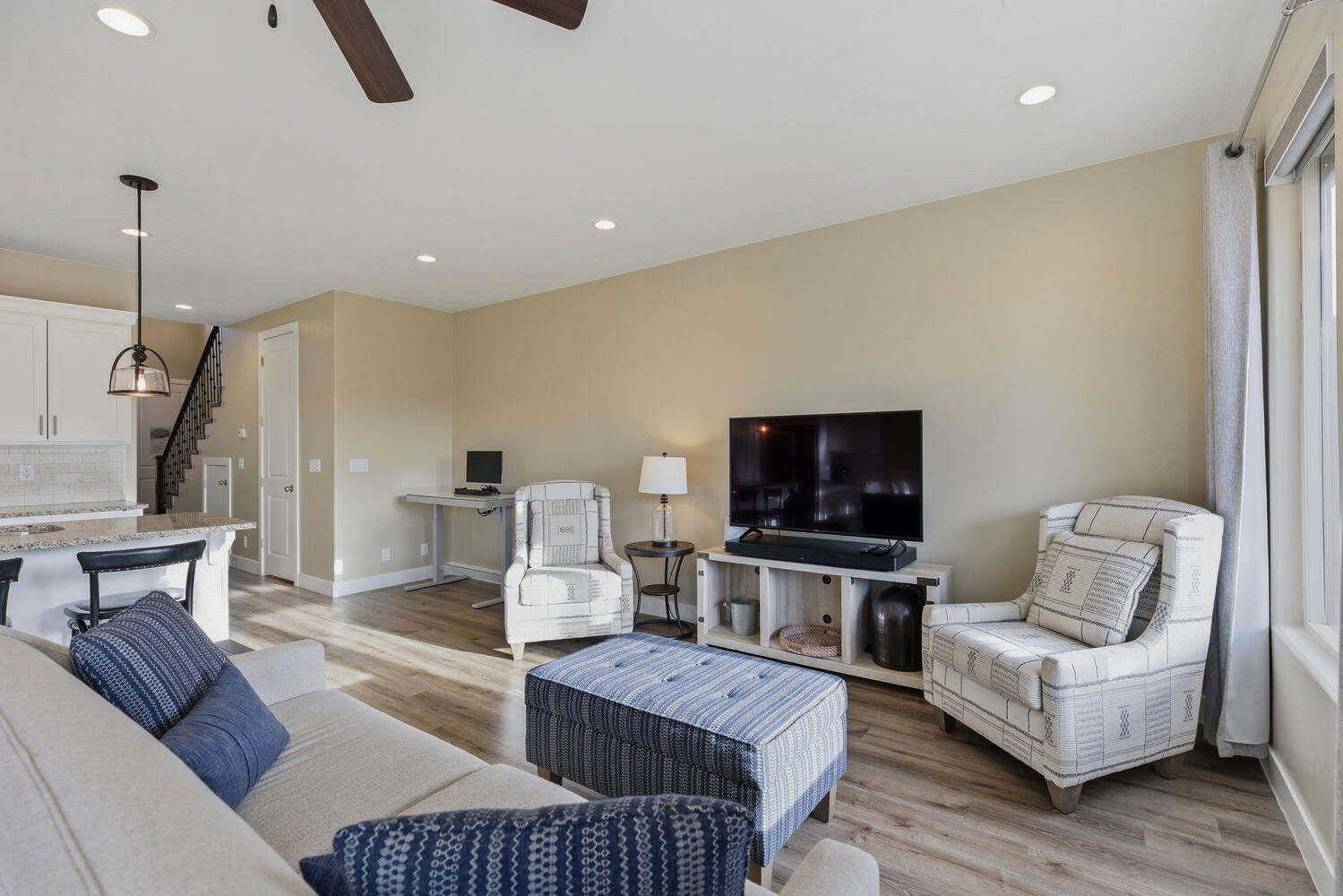 Living area with light wood-type flooring, ceiling fan, and recessed lighting