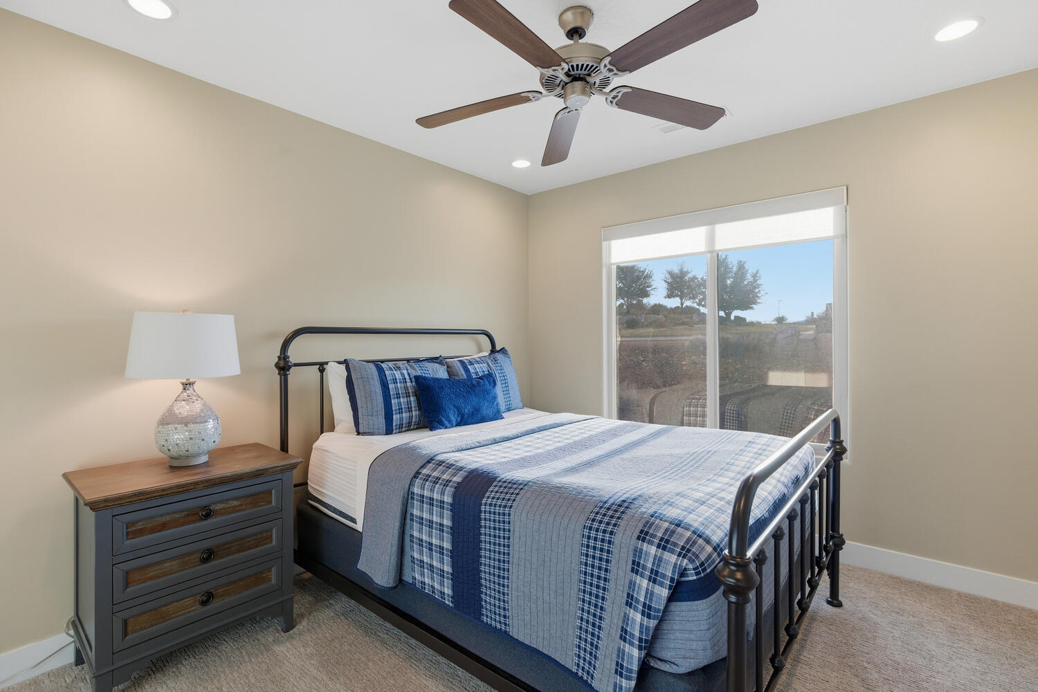 Bedroom with light carpet, a ceiling fan, and recessed lighting
