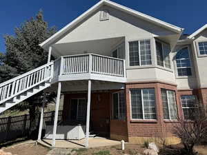 Rear view of property with a patio area and brick siding