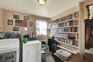 Laundry area featuring washer and dryer and wallpapered walls - can be converted back to a bedroom and Laundry Room could be moved back downstairs.