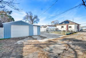 Detached garage featuring asphalt driveway