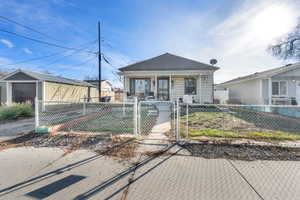 Bungalow with a gate and a fenced front yard, north facing.