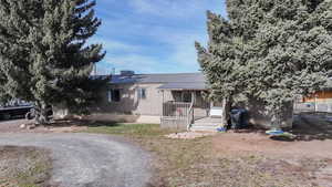 View of front of house featuring a metal roof and a porch