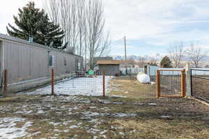 View of yard featuring a mountain view and a gate