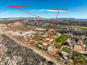 Aerial view of property's location featuring a mountain backdrop and property parcel outlined