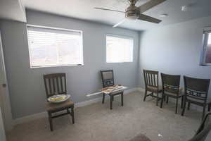 Bedroom featuring light colored carpet, a textured ceiling, a ceiling fan, and healthy amount of natural light