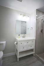 Bathroom with a stall shower, vanity, and a textured ceiling